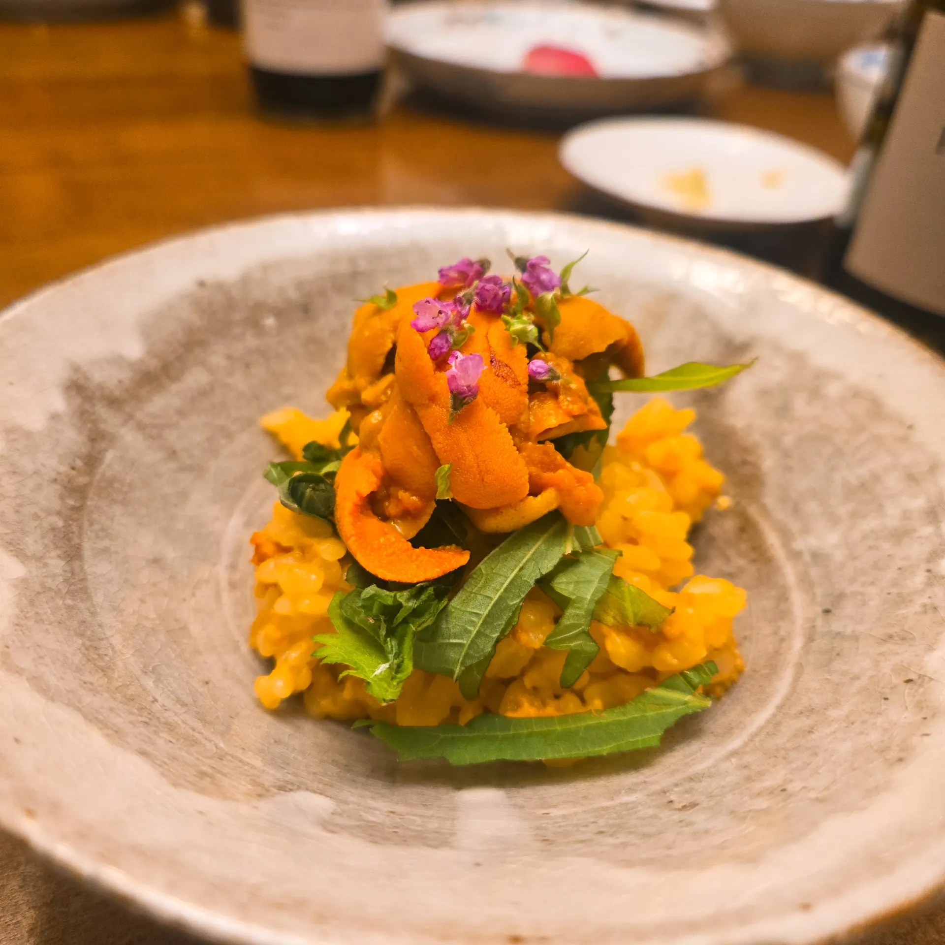 Uni Risotto — Hokkaido Uni over risotto with herbs and edible flowers